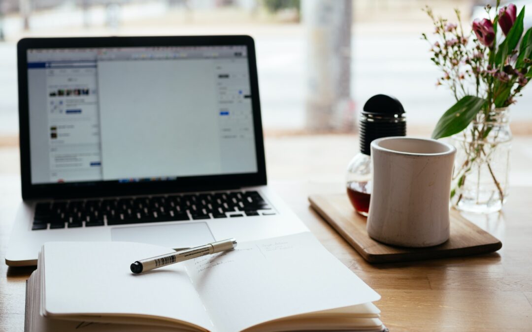 computer and journal on a desk